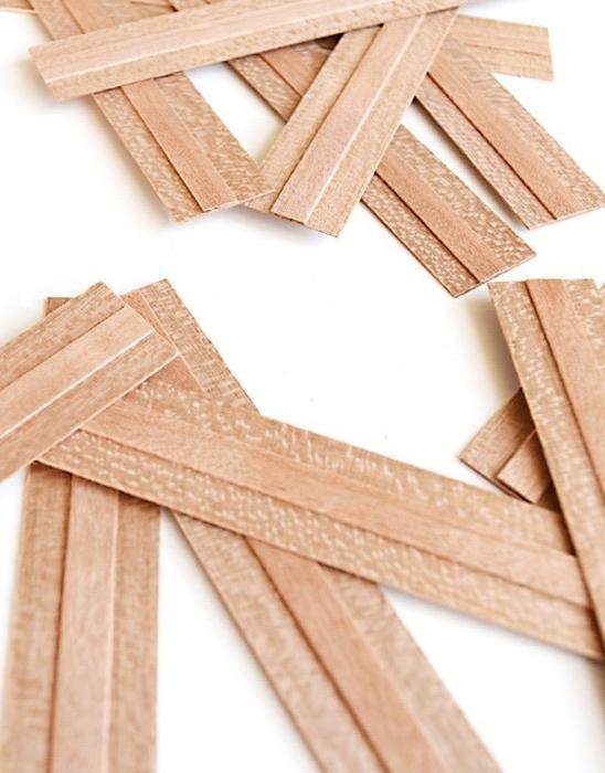 Wooden wicks arranged on a white background.