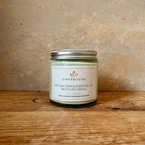 Gingerlilies Relaxing essential oil candle in small glass jar with silver lid, labelled "Natural Wax Neroli Roman Chamomile & Ylang Ylang", featuring orange leaf logo on white label.